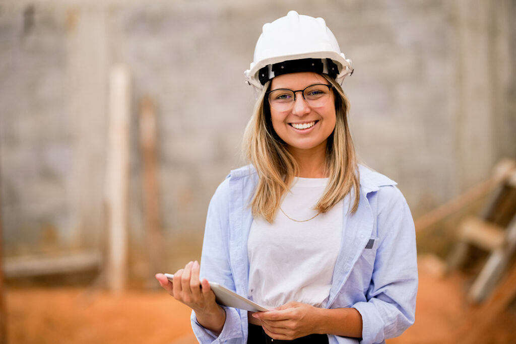 Portrait of a beautiful engineer woman at construction site